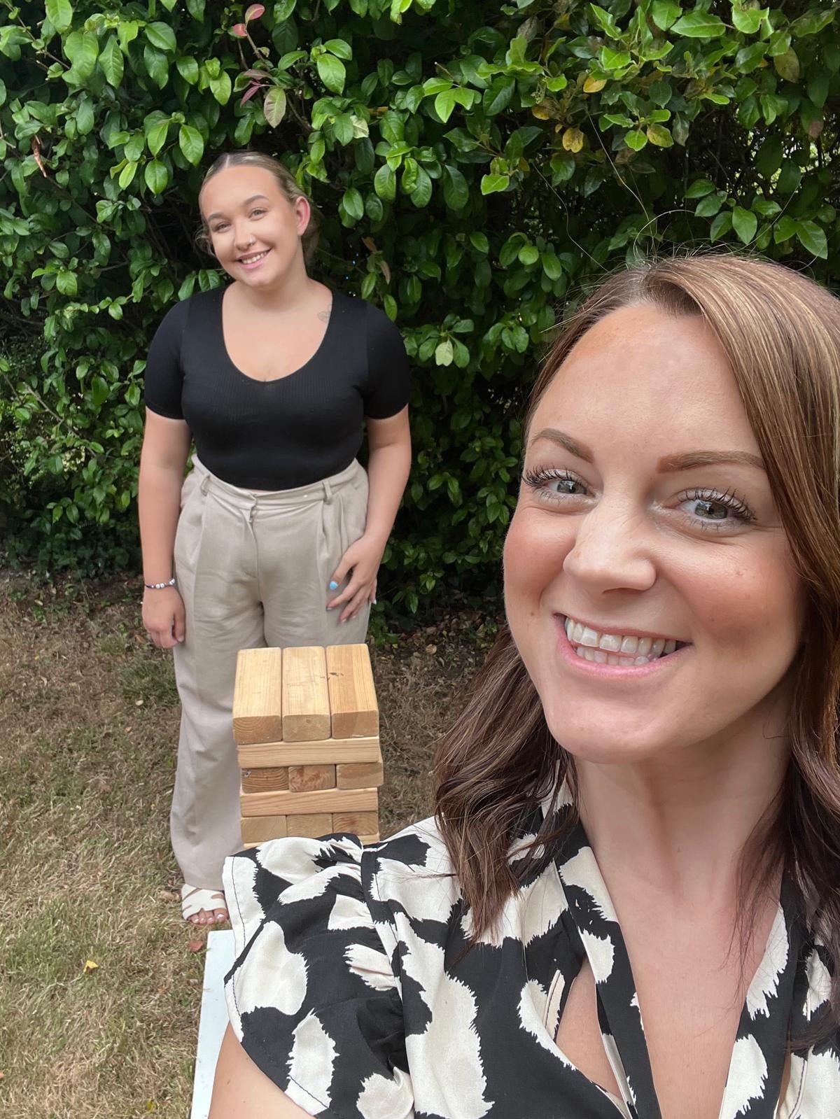 Team members playing giant Jenga at a social event